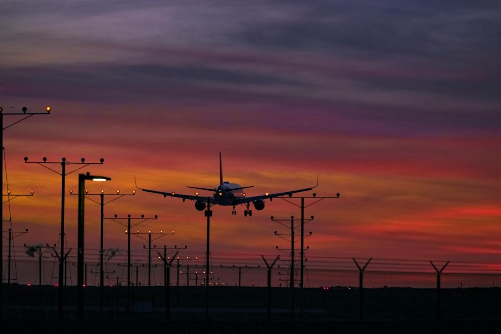 Airplane flying during the sunset